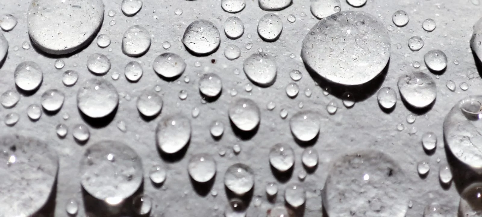 Superficie siliconada blanca con el agua perlada en gotas separadas